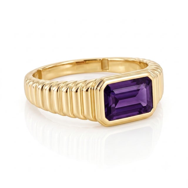Indulge in royal purple hues with this luxurious gemstone ring. Crafted with a thick 18k yellow gold-plated finish, this...