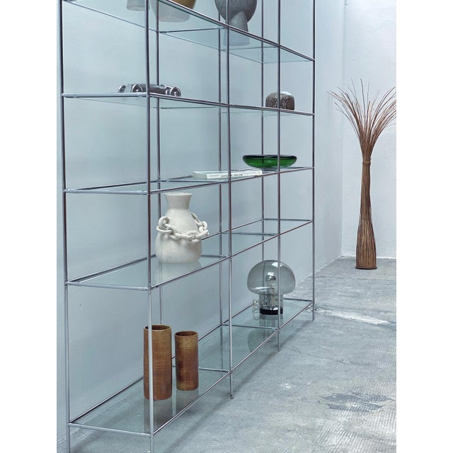 An absolutely stunning, minimalist, and delicate, and very rare interlocking shelf made of chrome-plated steel elements...