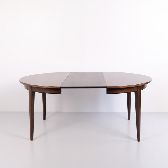 Round dining table model 55 designed and manufactured by Omann Jun in 1964. The table is made in rosewood veneer and...