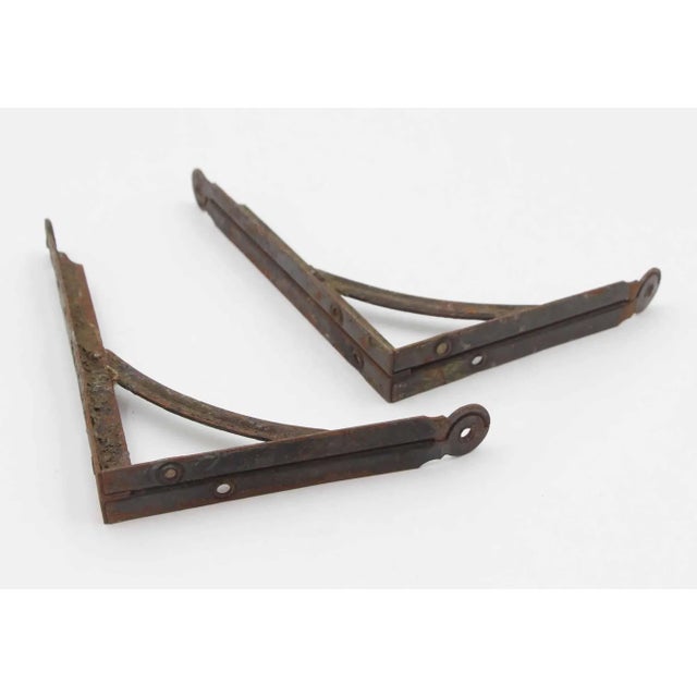 Utilitarian style shelf brackets made of steel with a black finish. The original mounting screws are not available. Good...