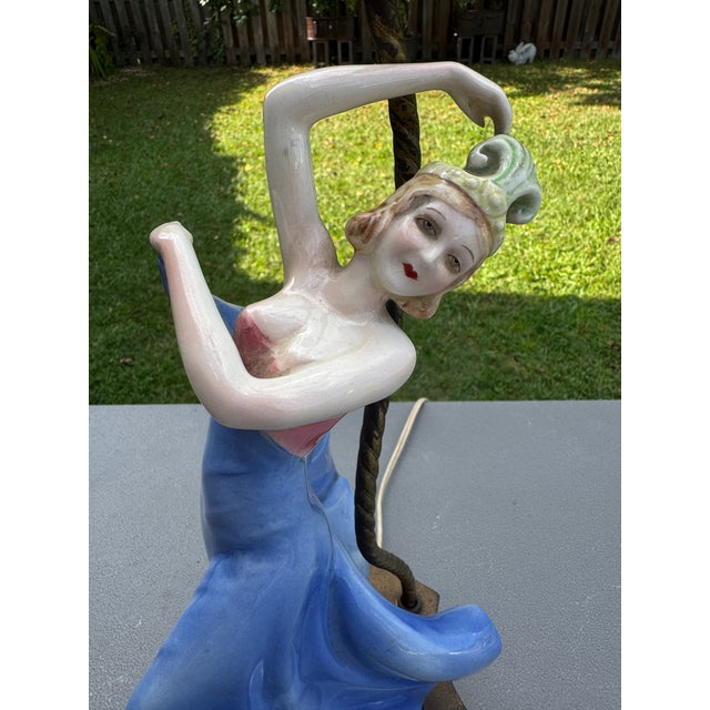 Offering for sale this exceptional, highly collectible vintage Art Deco figural porcelain table lamp featuring a graceful,...