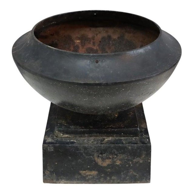 An antique cast iron garden urn, created in the manner of Fiske and dating to circa 1900. This robust piece features a...