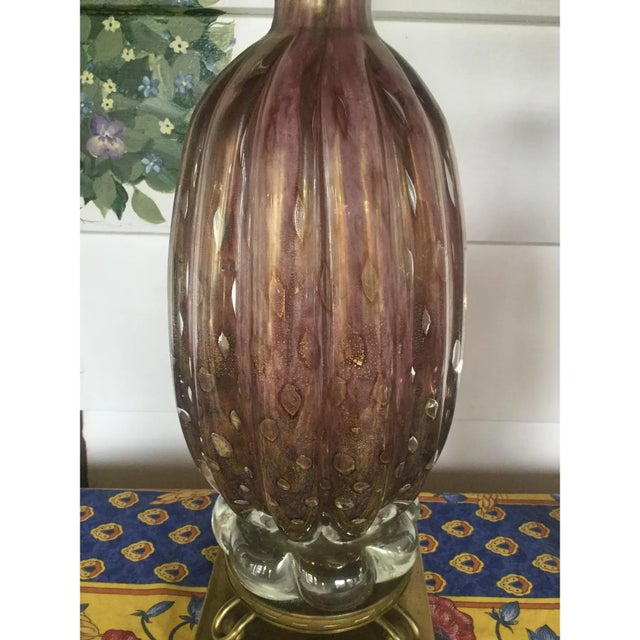 Stunning pair of Murano glass table lamps. The color is best described as amethyst and there are gold specks throughout,...