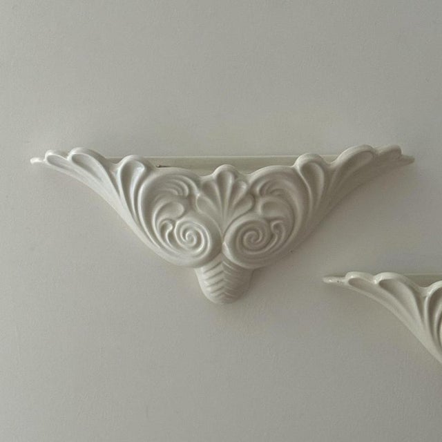 A pair of white ceramic “regency’ wall vases by George Clewes of England. W35 cm | H14 cm | D7cm Vintage condition.