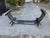 This Vintage Art Deco Tubular Smoked Glass coffee table by Romeo Rega features a stylish and unique design with a harp...