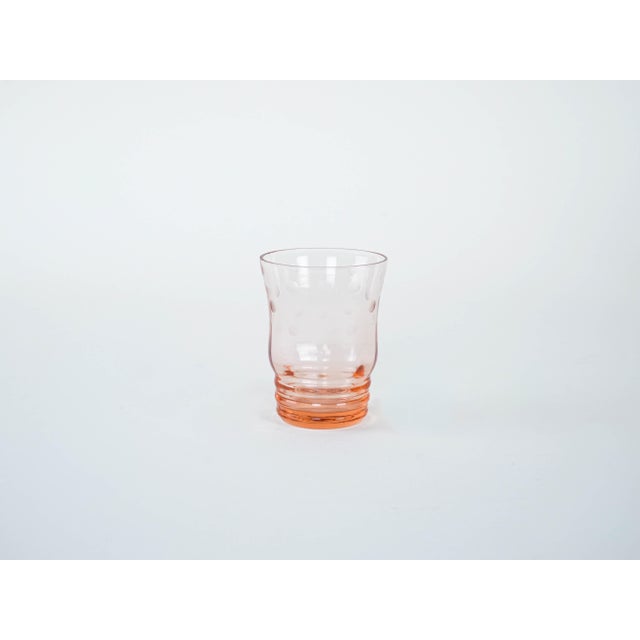 The set was made in the 1970s in Italy. A glass set consisting of a carafe and six glasses in a salmon-pink shade,...