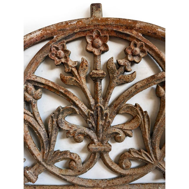 Vintage cast iron transom from India featuring an elegant arched silhouette with finely detailed floral and foliate...