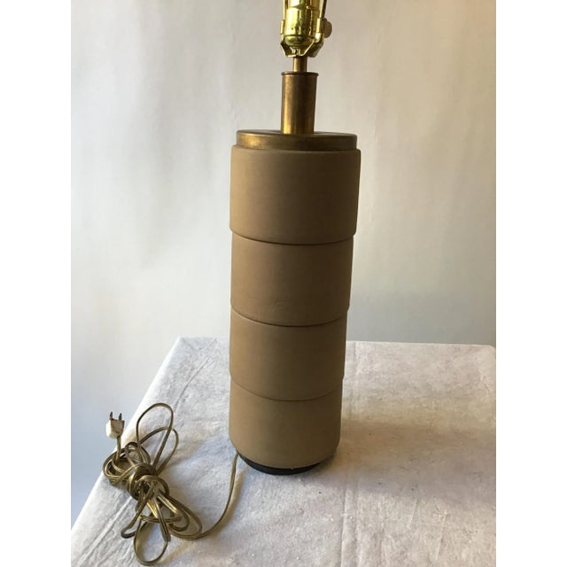 1950s cylindrical ceramic and brass lamp. Needs rewiring. Quite heavy.
