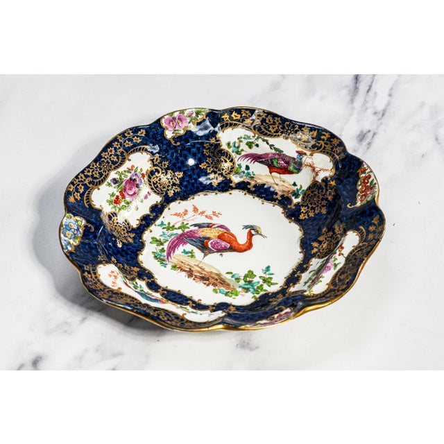 A captivating example of 19th-century English decorative artistry, this hand-painted porcelain plate is a true celebration...