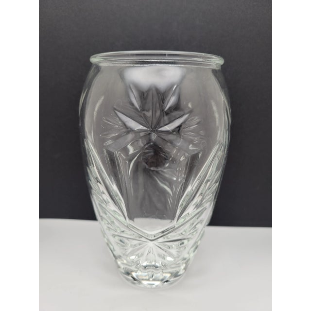 It features a clear crystal construction with a distinctive cut/whirling star and shield design, characteristic of the...