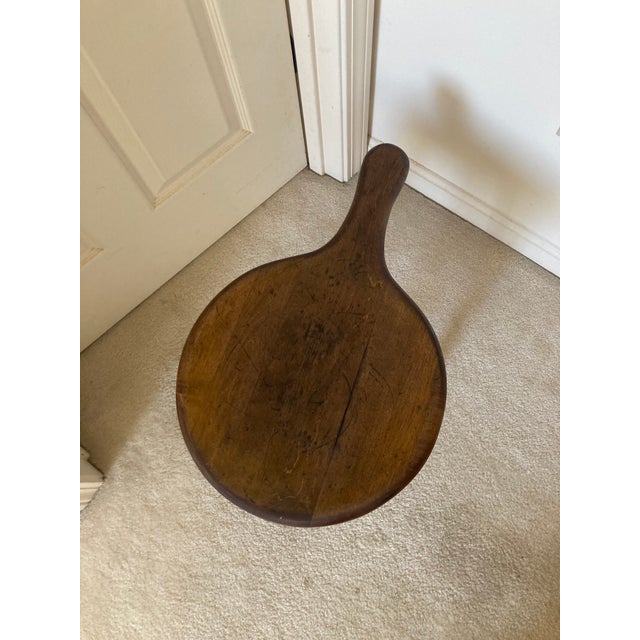 This is an early 20th century milking stool. It is of solid wood and is very sturdy. It can hold a lot of weight to be...