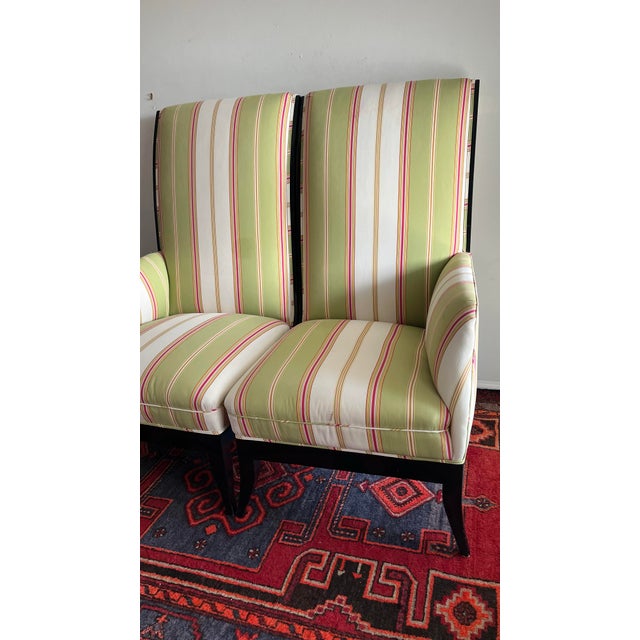 Pair of one armed highback chairs. Use separately or together to form a loveseat. Upholstered in a Palm Beach pink, green...