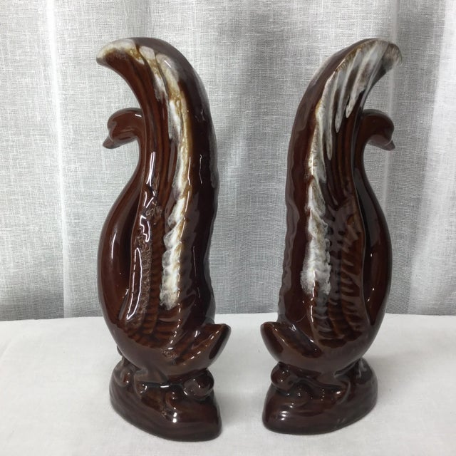 The iconic Mid Century brown glazed ceramic with white tips design is featured in this pair of mirrored swans. Elegant...