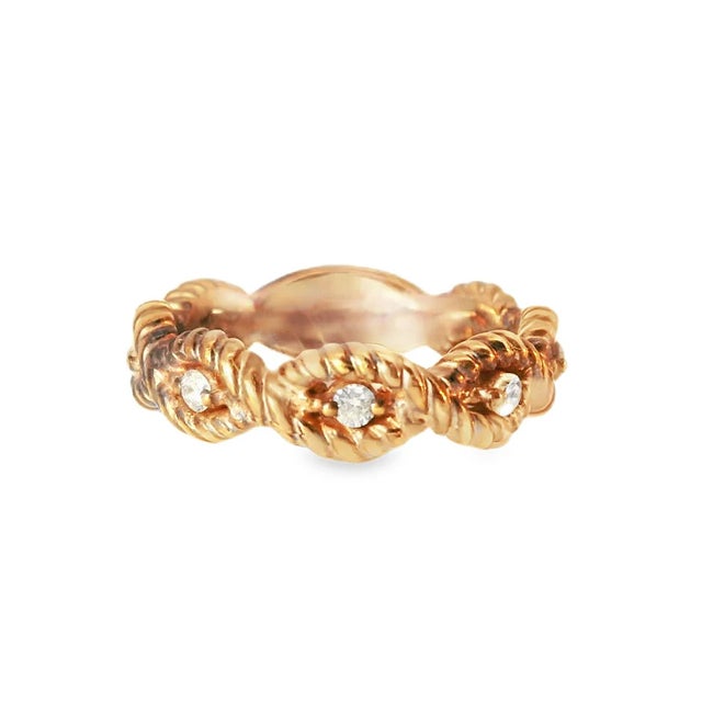14K pink rose gold eternity-style wedding band featuring 7 brilliant round diamonds. This elegant band combines the warm...