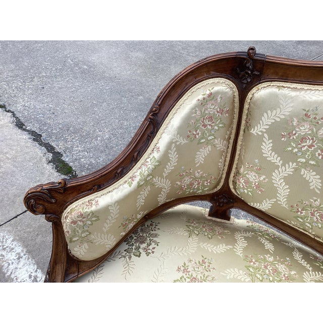 This is a classic French Settee circa 1920’s. With a beautifully carved walnut frame, this settee is upholstered in a rich...