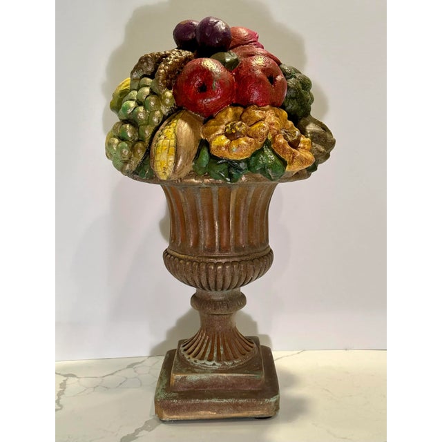 Heavy cast fruit arrangement sits atop a classic urn. Very charming and would look great anywhere in your home. I have to...