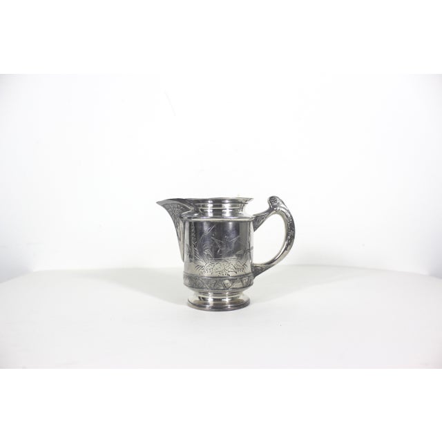 This is an antique (1800’s) Hartford Quadruple Silver Plate creamer, pitcher or vase. This has an embossed handle, spout...