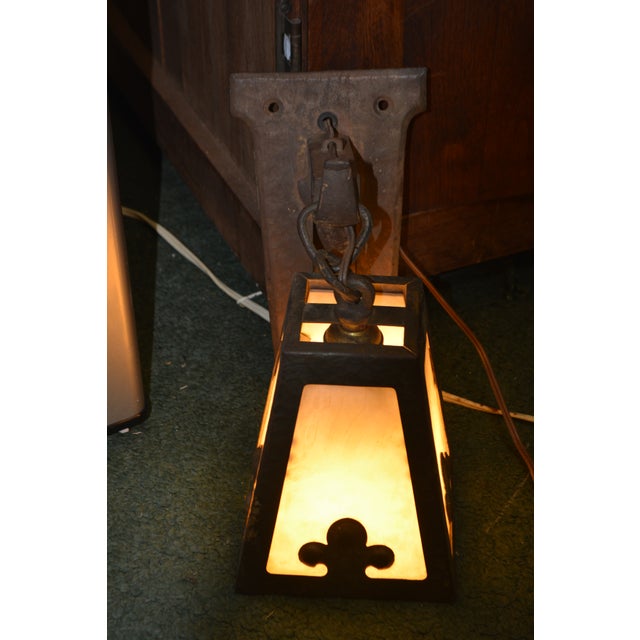 Love this light! Very Arts & Crafts with a medieval/gothic look. Works as it should. On/off pull chain. The back plate is...