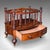 This is an antique Canterbury stand. An English, burr walnut three sectioned magazine or newspaper rack, dating to the...