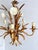 Gilt tole chandelier with five light arms, white tole florals and wheat motif detailing. Constructed of painted and gilt...