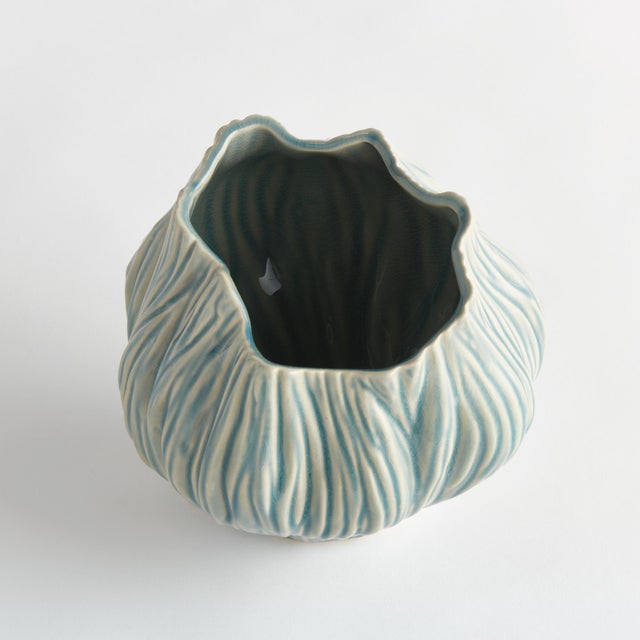 This artisanmade ceramic vase is a real beauty. The reactive glaze accentuates the natureinspired texture of the piece. A...