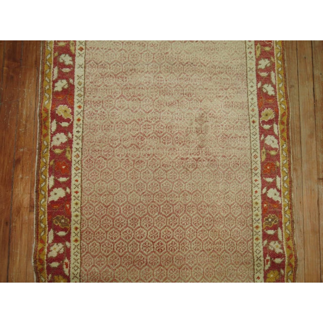 An early 20th century Turkish Oushak runner with a soft pink and cream field surrounded by a soft red border. Measures:...
