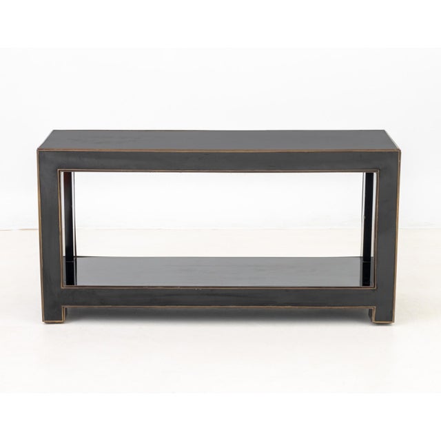 Maison Jansen Attributed Black Lacquered Brass Banded Console Table, with four legs conjoined by an undertier, in the...