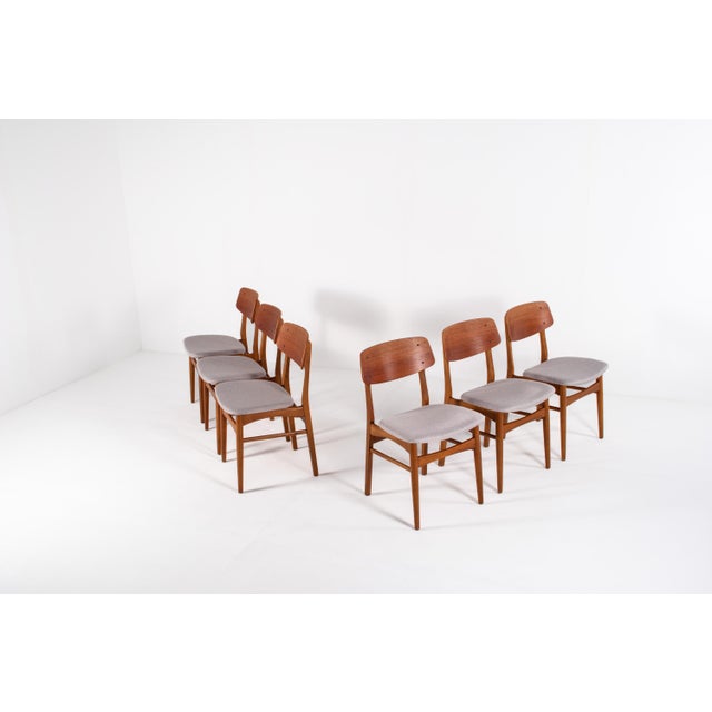 This is a set of six Danish Farstrup dining chairs, model 208A, made from solid teak. The chairs have a warm wood colour,...