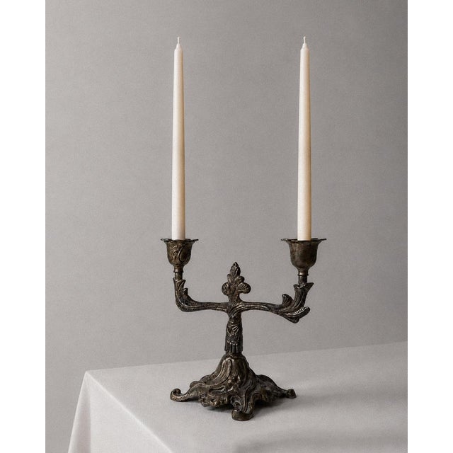 This vintage bronze candleholder from the 1910s is a beautifully detailed Art Deco piece designed to hold two candles....