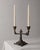 This vintage bronze candleholder from the 1910s is a beautifully detailed Art Deco piece designed to hold two candles....