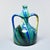 A vibrant and expressive Vallauris pottery ewer featuring the region's signature flowing multicolor glaze in cobalt blue,...