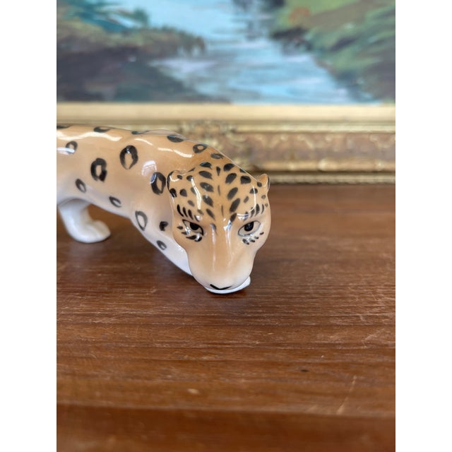 This vintage porcelain leopard figurine was produced by Erphila in Germany, known for its fine ceramic craftsmanship...