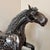 Elevate your space with this striking steampunk-style horse sculpture crafted entirely from recycled mechanical parts....