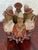 This handmade terracotta whistle sculpture shows a ring of Andean musicians in brimmed hats, each playing a traditional...