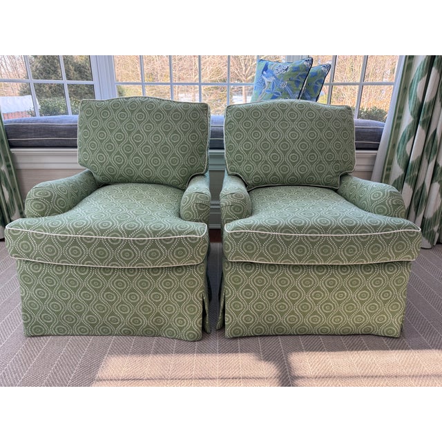 Elegant pair of custom swivel club chairs by O. Henry House, known for their exceptional craftsmanship and timeless...