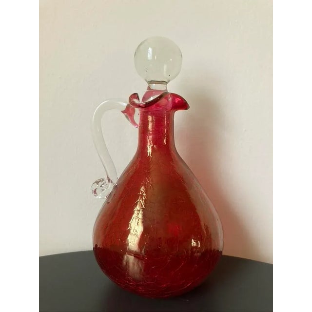 A beautiful hand blown glass liquor or spirits decanter, circa mid-20th century, USA. Decanter is brightly colored in...