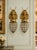 A decorative pair of late 20th-century French Louis XVI–style wall sconces, crafted in bronze with a warm gilt finish and...