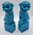 A striking pair of Chinese guardian lions, also known as Fu Dogs, rendered in a vibrant turquoise glaze with a softly...