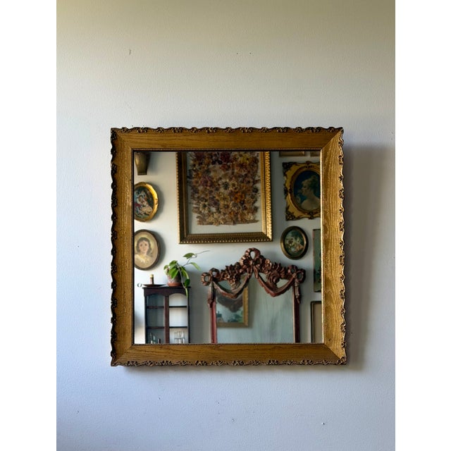 Vintage giltwood wall mirror dating to the 1940s–50s. Features a wide gold frame with delicate Louis XV-inspired detailing...