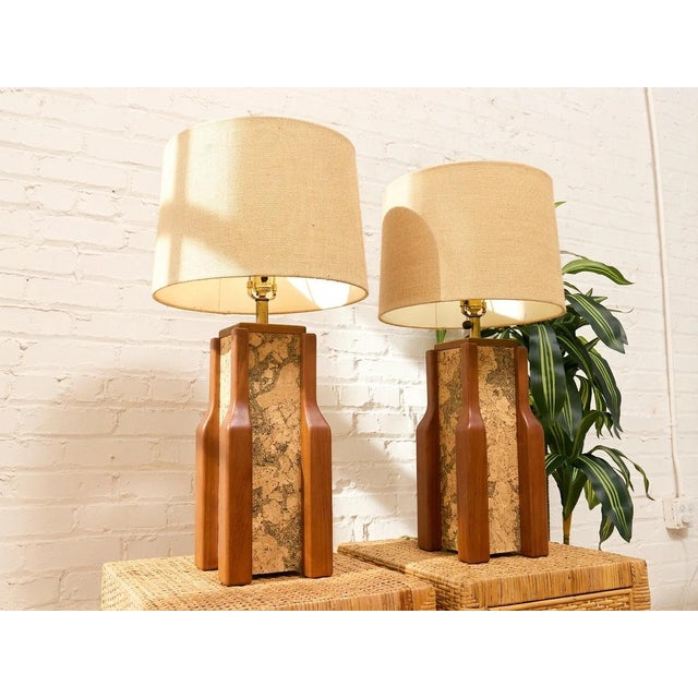striking vintage table lamp combining warm walnut with a richly textured cork center panel. The tall rectangular body is...