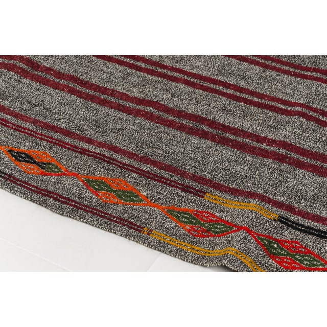 This is a vintage Turkish Oushak rug from the Mid 20th Century. The piece was hand-knotted.