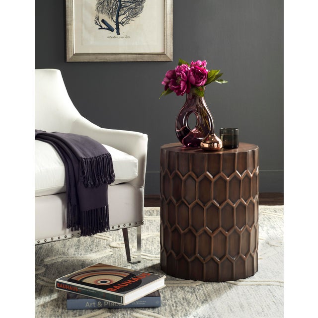 A contemporary auction catalogue for a modernist Hungarian sculptor inspired this side table. a antique copper finish adds...