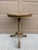 An elegant Regency-style flip-top side table in painted walnut, featuring hand-painted gold decoration against a soft...