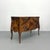A striking vintage bombe chest showcasing an exceptional patchwork burl wood veneer with rich organic grain and dramatic...