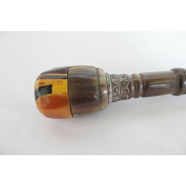 Stunning antique walking stick or gadget cane. Handle composed of horn discs in various tones of amber, brown, and...