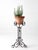 Antique Victorian wrought iron plant stand featuring twisted iron uprights, scrolling feet, and intricate foliate details....