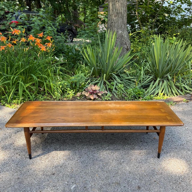 An iconic piece from Lane’s beloved Acclaim collection, this rectangular walnut coffee table features the series’...