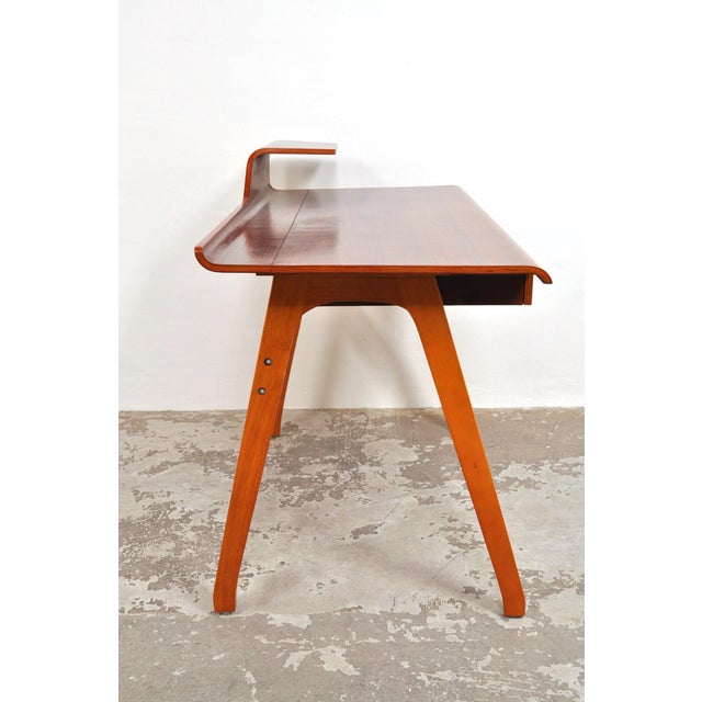 Beautifully designed and curved teak desk with contrasting lighter-colored hardwood legs. Truly stunning and in very good...