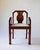 Distinctive Art Deco armchair with armrests, dating from around 1930. The chair features a richly finished wooden frame...