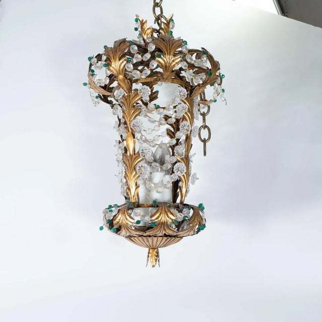 Gilt metal, lantern style pendant with foliate motif and crystal leaf and flower details in the manner of Bagues.